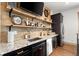 Stylish bar area features granite countertops, wood plank accent wall, and custom shelving with stainless steel appliances at 49 Waterside Se Dr, Cartersville, GA 30121