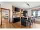 Well-equipped bar area with counter seating, cabinets, adjacent to a game room and windows at 49 Waterside Se Dr, Cartersville, GA 30121