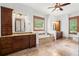 Primary bathroom featuring dual sinks, vanities, soaking tub and natural light at 49 Waterside Se Dr, Cartersville, GA 30121