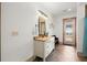 Bright bathroom featuring a vanity with stone countertop and exterior door at 49 Waterside Se Dr, Cartersville, GA 30121