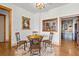 Charming dining area with wood floors, wine storage view, and decorative painting at 49 Waterside Se Dr, Cartersville, GA 30121