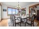 Bright dining room with large table, chandelier, and views of nature from the expansive windows at 49 Waterside Se Dr, Cartersville, GA 30121