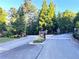 Picturesque gated community entrance with stone pillars, black gate and lush landscaping at 49 Waterside Se Dr, Cartersville, GA 30121