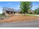 Charming exterior featuring a three-car garage, lush landscaping, and manicured lawn at 49 Waterside Se Dr, Cartersville, GA 30121