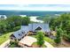 Stunning home with lake view, multiple garages, beautiful landscaping, and architectural roof in a serene, wooded setting at 49 Waterside Se Dr, Cartersville, GA 30121