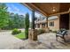 Inviting covered porch with stone pillars and chairs, perfect for relaxing outdoors at 49 Waterside Se Dr, Cartersville, GA 30121