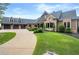 Exterior of home with a three-car garage, manicured lawn, and lush landscaping at 49 Waterside Se Dr, Cartersville, GA 30121