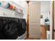 Well-equipped laundry room with modern washer and dryer units and storage shelves at 49 Waterside Se Dr, Cartersville, GA 30121