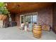 Charming covered patio with cozy seating, wood details, and beautiful landscape at 49 Waterside Se Dr, Cartersville, GA 30121
