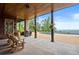 Relaxing outdoor patio with stone columns, a barrel table, and scenic views at 49 Waterside Se Dr, Cartersville, GA 30121
