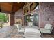 Inviting patio with stone fireplace, comfortable seating, and wooded views at 49 Waterside Se Dr, Cartersville, GA 30121