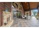 Inviting outdoor patio with stone fireplace, comfortable seating and wooded views at 49 Waterside Se Dr, Cartersville, GA 30121