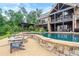 Breathtaking pool area with a stone fire pit and scenic backyard views at 49 Waterside Se Dr, Cartersville, GA 30121