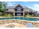Expansive backyard featuring a luxurious pool, lush landscaping, and outdoor seating at 49 Waterside Se Dr, Cartersville, GA 30121