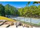 Well-maintained tennis court surrounded by lush greenery at 49 Waterside Se Dr, Cartersville, GA 30121