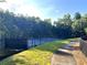 Well-maintained community tennis court surrounded by lush greenery and trees at 49 Waterside Se Dr, Cartersville, GA 30121