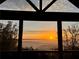Spectacular sunrise vista over mountain range and valley, seen from expansive picture window at 49 Waterside Se Dr, Cartersville, GA 30121