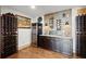 Dedicated wine cellar boasting custom wine racks, granite countertops, ample storage, and a sleek wine fridge at 49 Waterside Se Dr, Cartersville, GA 30121