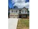Two story home with a two car garage, dark shutters, and brick accents at 742 Great Oak Pl, Villa Rica, GA 30180
