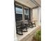 Relax on the cozy front porch with rocking chairs, perfect for enjoying the outdoors at 742 Great Oak Pl, Villa Rica, GA 30180