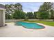 Backyard featuring a kidney-shaped pool and concrete perimeter at 1197 Kenilworth Trce Trce, Snellville, GA 30078