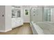Luxurious bathroom featuring a soaking tub, glass-enclosed shower, and vanity, providing a spa-like experience at home at 1197 Kenilworth Trce Trce, Snellville, GA 30078