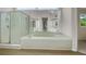 Modern bathroom with a soaking tub, glass-enclosed shower, and large mirror, creating a bright and open space at 1197 Kenilworth Trce Trce, Snellville, GA 30078