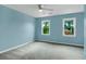 Inviting bedroom with modern ceiling fan, two windows, and cozy carpet, creating a peaceful and comfortable environment at 1197 Kenilworth Trce Trce, Snellville, GA 30078