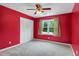 Carpeted bedroom featuring double door closet, ceiling fan, and natural light at 1197 Kenilworth Trce Trce, Snellville, GA 30078