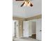 Bright bedroom with a ceiling fan, neutral paint, and connecting doors at 1197 Kenilworth Trce Trce, Snellville, GA 30078