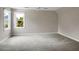 Expansive bedroom featuring a ceiling fan, two windows, and neutral carpet, providing a flexible space for relaxation and personalization at 1197 Kenilworth Trce Trce, Snellville, GA 30078