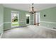Airy dining room featuring a modern chandelier, neutral paint, and large windows at 1197 Kenilworth Trce Trce, Snellville, GA 30078