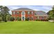 Charming two-story brick home with a large front yard and mature landscaping, perfect for families or those who enjoy outdoor space at 1197 Kenilworth Trce Trce, Snellville, GA 30078