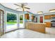 Eat-in kitchen featuring tile floors, stainless appliances, an island, and large windows with a view of the pool at 1197 Kenilworth Trce Trce, Snellville, GA 30078
