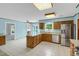 Bright kitchen with white tile floors, stainless steel appliances, and a central island offering ample counter space and storage at 1197 Kenilworth Trce Trce, Snellville, GA 30078