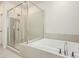 Modern bathroom features a separate shower and soaking tub with tiled surround at 1247 Winterhaven Dr, Cumming, GA 30041