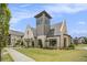 Exterior of a modern clubhouse with architectural design, complemented by manicured landscaping, a sidewalk, and a grassy lawn at 1247 Winterhaven Dr, Cumming, GA 30041
