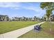 Picturesque view of community lawn area with benches and a walking path, set against a backdrop of beautifully designed buildings at 1247 Winterhaven Dr, Cumming, GA 30041