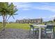 Scenic outdoor seating area, with tables and chairs, providing a relaxing space amidst a lush green landscape and community view at 1247 Winterhaven Dr, Cumming, GA 30041