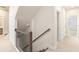 Hallway view with stairwell and bedroom access at 1247 Winterhaven Dr, Cumming, GA 30041
