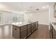 Spacious open kitchen featuring a large granite island and stainless steel appliances at 1247 Winterhaven Dr, Cumming, GA 30041
