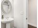 Stylish powder room with pedestal sink, modern fixtures, and neutral color scheme at 1247 Winterhaven Dr, Cumming, GA 30041
