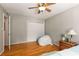 Spacious bedroom featuring wood floors, double closet, and serene neutral walls at 1445 Monroe Ne Dr # 14B, Atlanta, GA 30324