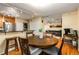 Inviting dining area with wood floors, a breakfast bar, and a view into the spacious living room at 1445 Monroe Ne Dr # 14B, Atlanta, GA 30324