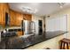 Kitchen with stainless steel appliances, dark countertops, bar seating and stacked washer/dryer in the background at 1445 Monroe Ne Dr # 14B, Atlanta, GA 30324