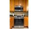 Close up of a stainless steel oven and microwave, surrounded by light wood cabinets at 1445 Monroe Ne Dr # 14B, Atlanta, GA 30324