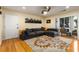 Bright living room featuring a plush grey sofa, a stylish rug, and an open doorway to the outdoor patio at 1445 Monroe Ne Dr # 14B, Atlanta, GA 30324