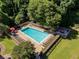 Aerial view of a community pool surrounded by greenery, lounge chairs, and a wooden fence at 1445 Monroe Ne Dr # 14B, Atlanta, GA 30324