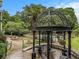 View of the pool with a gazebo in a garden setting surrounded by lush greenery and landscaping at 1445 Monroe Ne Dr # 14B, Atlanta, GA 30324