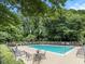 Community pool with lounge chairs, tables, and greenery offering a relaxing outdoor space at 1445 Monroe Ne Dr # 14B, Atlanta, GA 30324